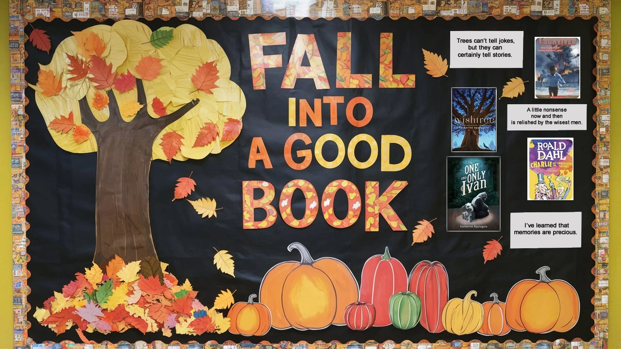 Bulletin board display with a fall theme titled 'Fall Into a Good Book,' featuring a large tree with autumn leaves and various pumpkins. The display highlights several book covers and quotes, encouraging students to read. The background is black with a fall-themed border.